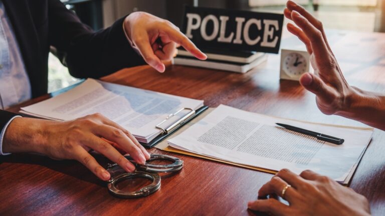 Law enforcement officer interrogating criminals male