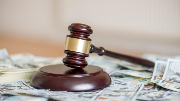 wood gavel and cash bonds