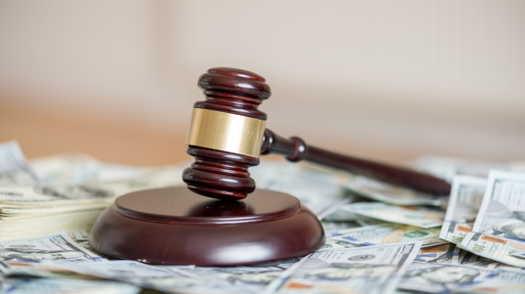 wood gavel and cash bonds